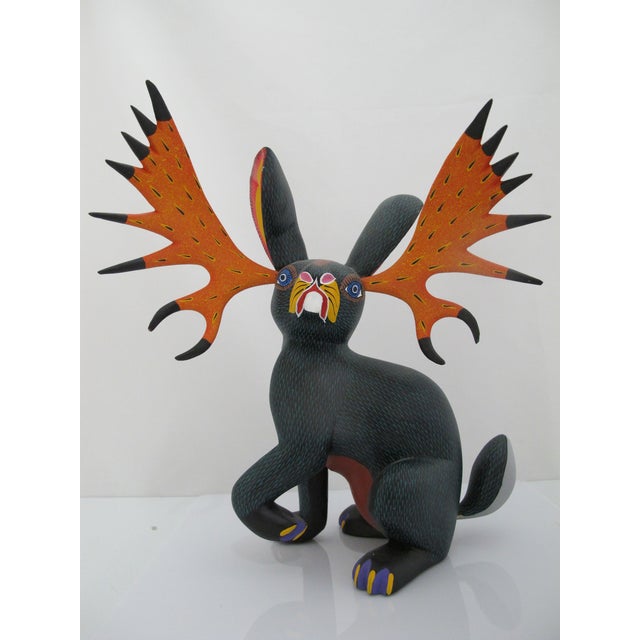 Hand-carved and hand-painted Oaxacan Alebrije sculptural figurine depicting a whimsical jackalope. Hand crafted from copal...