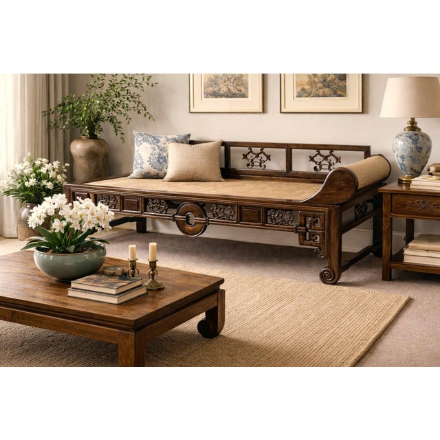 A striking late Qing period Chinese kang daybed or opium couch made of solid Chinese elm and featuring a beautifully...