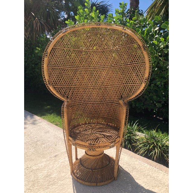 This classic peacock chair gives shape with simple rattan reeds woven into a beautiful hourglass frame and a fan-like...
