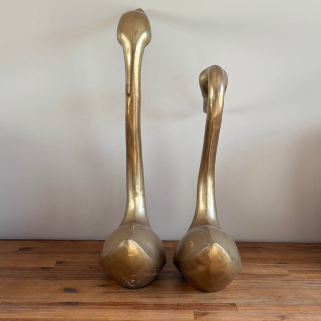 A sculptural vintage pair of large brass swans with a great clean mid-century look. The elongated necks and simple...