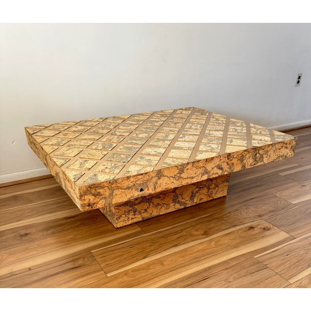 This gorgeous vintage cork coffee table captures attention through the compelling contrast between the natural, earthy...