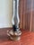 Antique glass finger lamp (chamber lamp) with side finger loop handle for carrying. Clear glass reservoir with squat base...