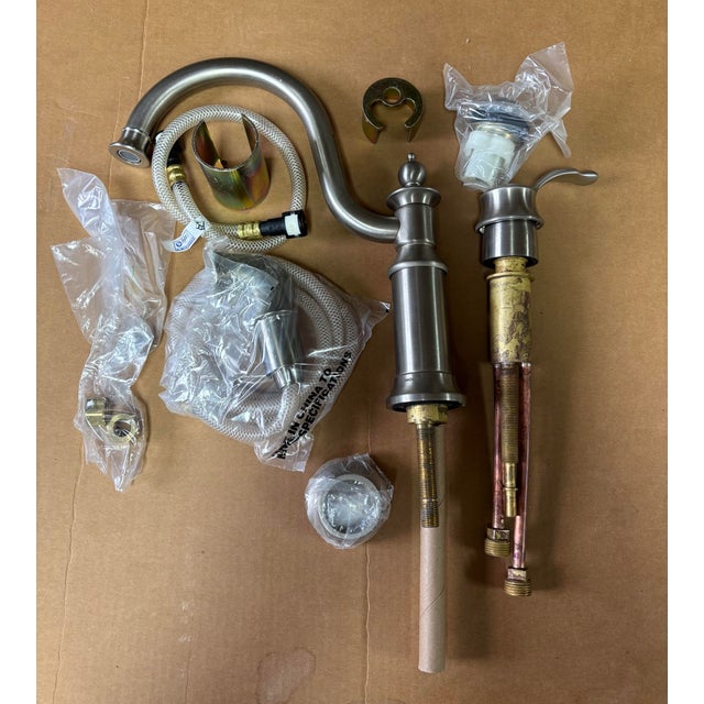 Show House One Handle Kitchen Faucet by Moen with Sprayer never been used in brushed nickel.