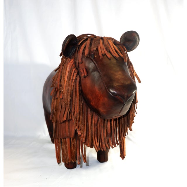 A handmade leather lion footstool This friendly lion footstool features a lush mane and an antique finish. Handcrafted...