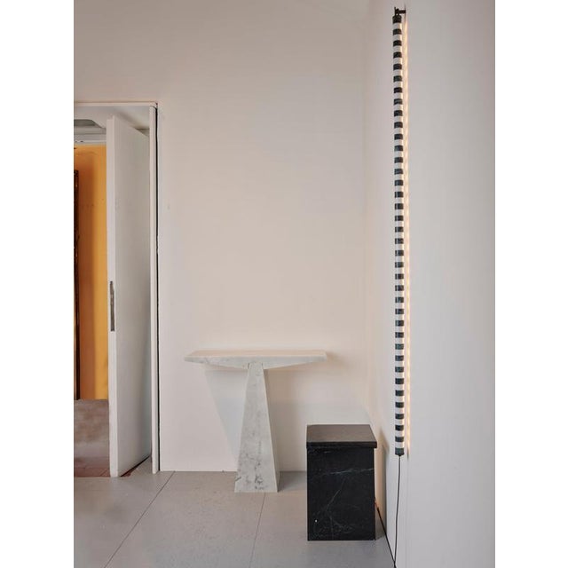 Alcm vertical wall lamp in verde alpi & carrara marbles by bufalini design dimensions: d 3 x w 3 x h 150 cm. Materials:...
