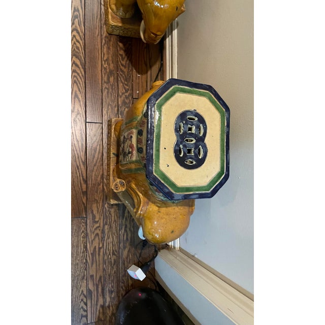 Rare matching pair of vintage ceramic elephant garden stools. The green elephants are decorated with colorful drapes in...