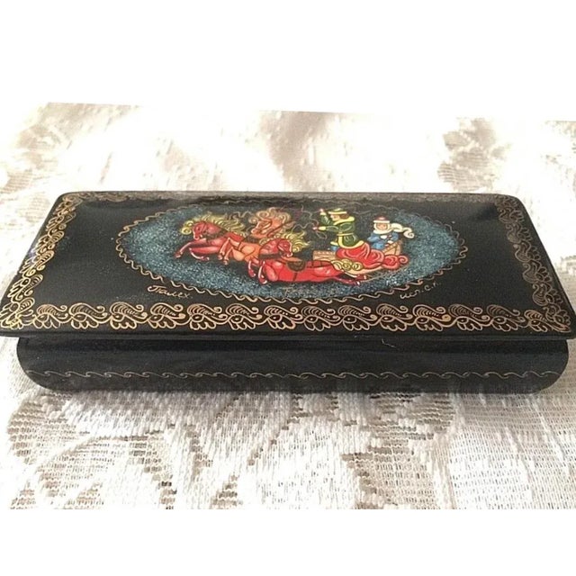 This is a beautiful hand-painted antique Russian enamel box measuring 5 1/2" X 2 1/2" X 1" depicting a man and woman on a...