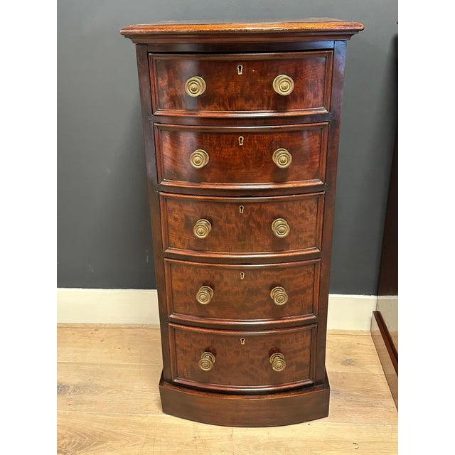 Beautiful set of antique curved mahogany bedside tables. Fitted with 5 drawers featuring bronze knobs. Beautiful patina....