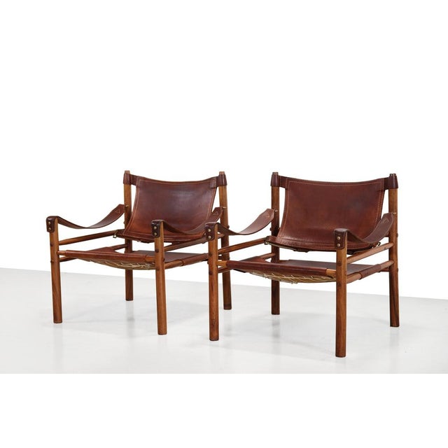 Two beautiful chairs by Arne Norell, model Sirocco, also known as safari lounge chairs. These two Scirocco easy chairs are...