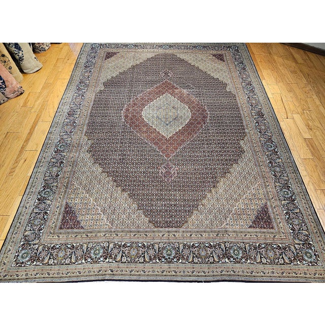 A magnificent early 20th century Persian Tabriz Mahi oversize rug hand-knotted by master artisans in one of the finest...