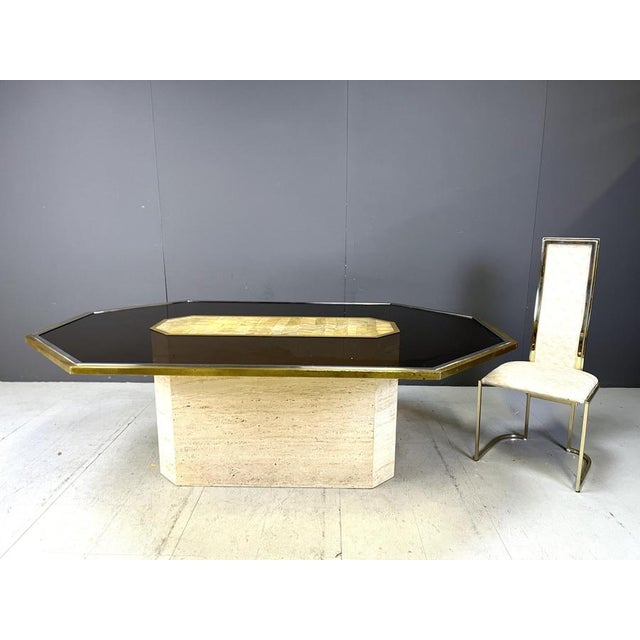 Very rare etched brass art table by Roger Vanhevel. The table has a chrome and brass frame with a smoked glass top mounted...
