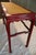 This stunning Swaim console table showcases a hand-rubbed cinnabar red finish with a natural woven raffia top, creating...