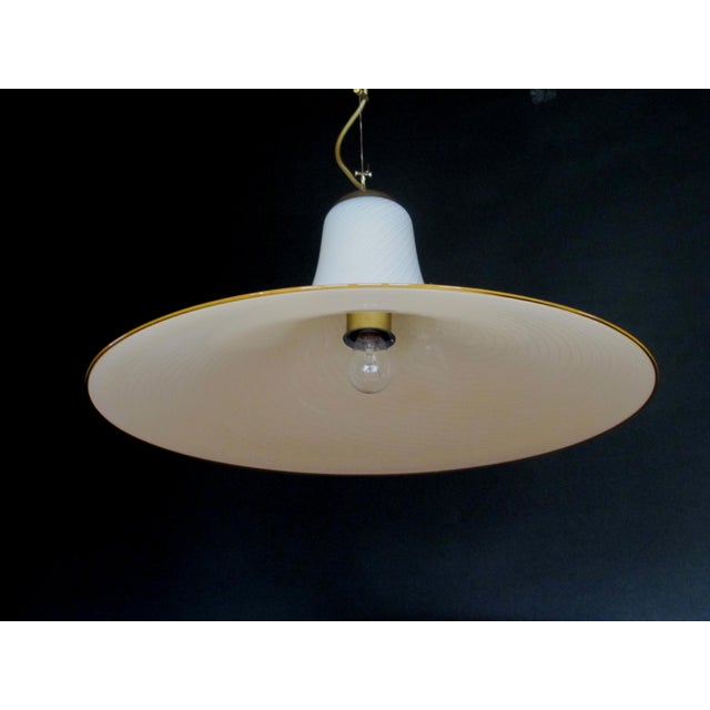 Hand-made murano glass pendant lamp made by Kalmar. The cable is adjustable from 30cm to 1m and the brass mount has a...