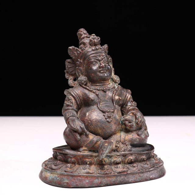 This is a finely crafted antique gilt bronze sculpture of Yellow Jambhala, the Buddhist deity of wealth and prosperity....