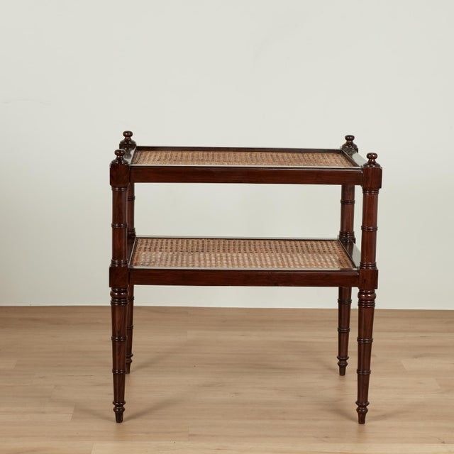 Handsome antique British colonial stand crafted in rosewood with two hand caned tiers on classic turned faux bamboo...