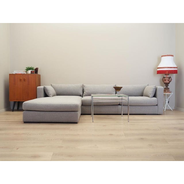 The corner sofa was made after 2000, Scandinavian design. The structure of the furniture is made of wood. The sofa has...