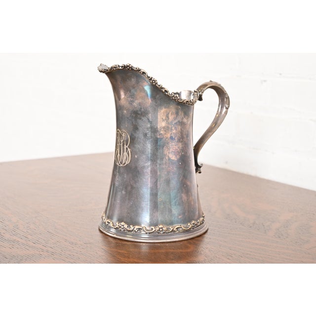 A gorgeous antique Victorian silver soldered repoussé pitcher By Tiffany & Co. USA, Late 19th Century Measures: 8"W x...