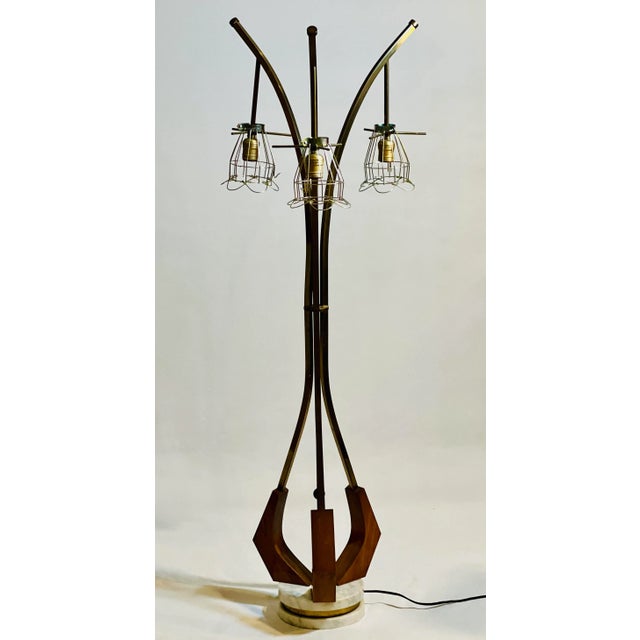 Vintage Danish modern three-light floor lamp, circa 1960s. Unique sculptural organic form lamp crafted of brass and teak...