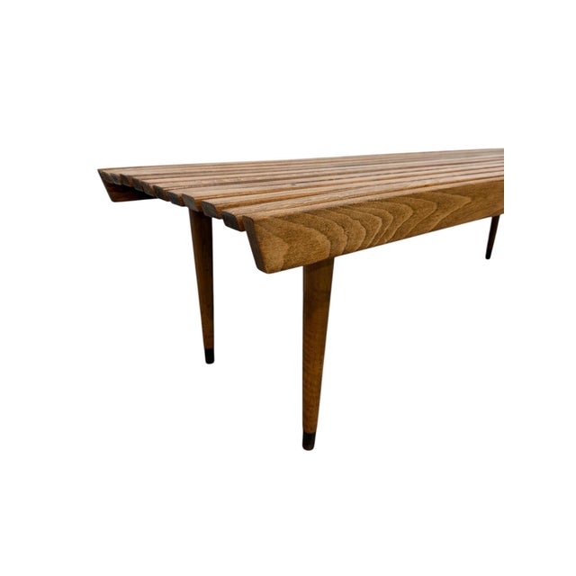 This stunning 60” mid-century modern walnut slatted coffee table is a true statement piece, showcasing the bold...