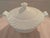 A like-new 1.5-quart covered vegetable dish by Villeroy & Boch in the "Arco Weiss" pattern of an embossed fan design, and...