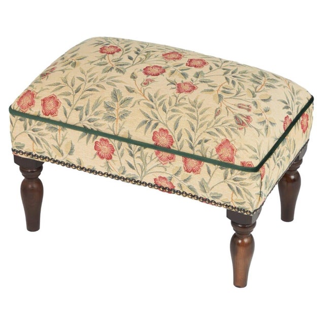 Meticulously handcrafted in the United Kingdom, this upholstered stool boasts classic studding and hand-polished solid...