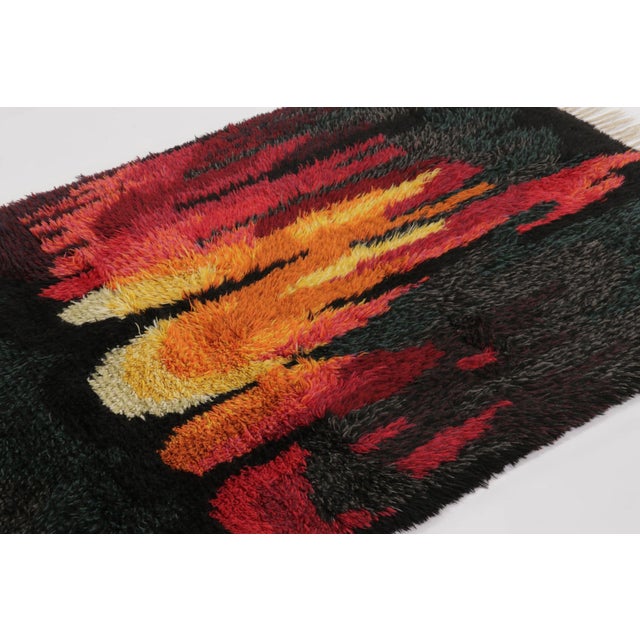Hand-knotted in lush, high-pile wool in Sweden circa 1960-1970, this 4x6 vintage Swedish Rya rug is a bold new addition to...