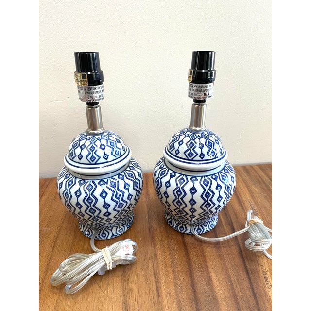 These ceramic ginger jar lamps features a blue and white geometric pattern Add your own shades Porcelain body: 7” H Full...