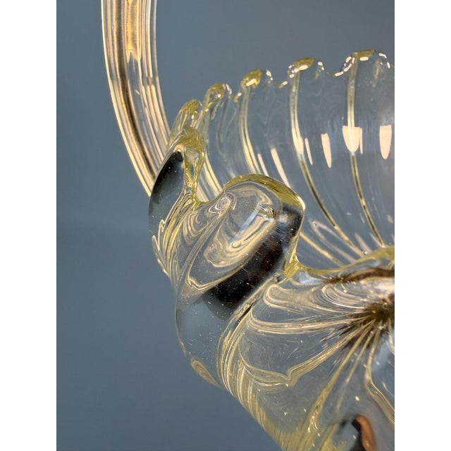 We are pleased to offer this exquisite Italian Pendant from the 1930s, handcrafted in clear Murano glass with brass...