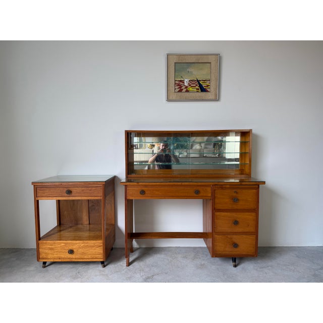 This beautiful 1950’s Mid-Century Modern desk features a warm honey-toned solid wood construction with clean lines and a...
