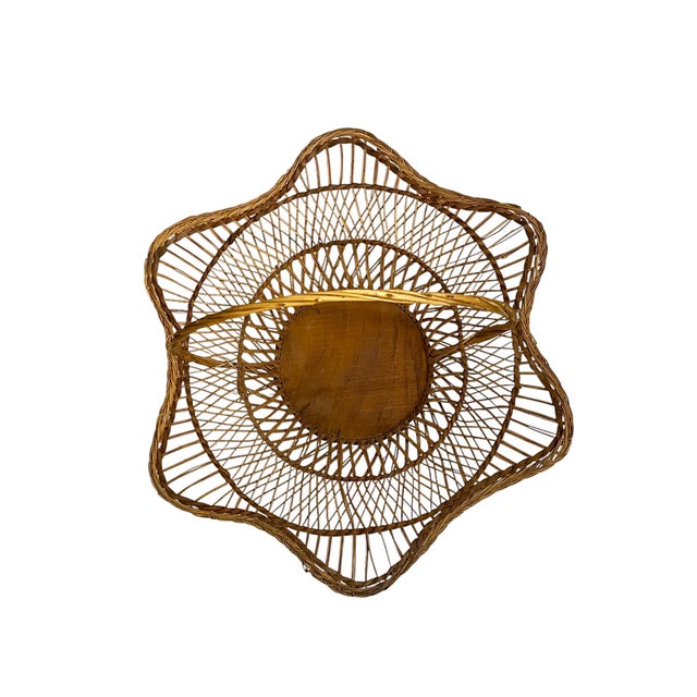 Charming vintage handwoven rattan basket featuring an elegant scalloped edge and arched handle. This beautifully crafted...