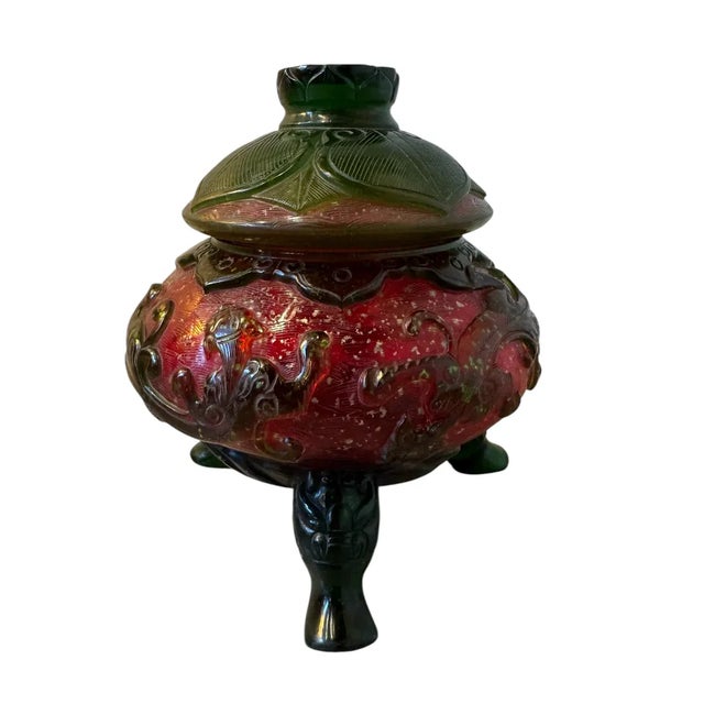 6 1/4”W x 6 3/4”H x 6 1/4”D Behold an exquisite example of Chinese decorative arts: a Peking overlay glass censer, its...