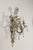 A pair of French Maison Baguès crystal sconces from circa 1940 with three arms each and floral motifs. Embodying the...