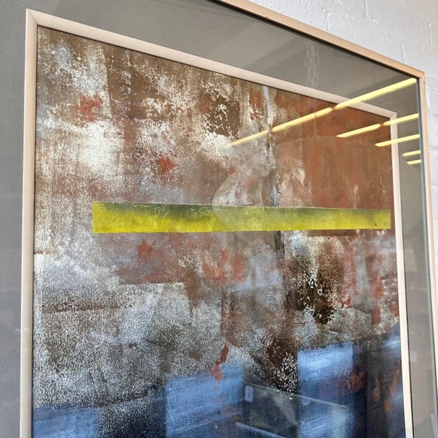 Matted abstract mixed media artwork featuring tones of blue, chartreuse and terra cotta. Framed in birchwood and very...