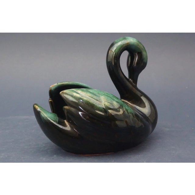 Beautiful swan-shaped cachepot made of majolica-glazed ceramic with a metallic luster finish. Beneath it is a distinctive...