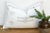Two small star motifs sit above a stacked diamond medallion on this handcrafted Moroccan cactus silk lumbar pillow, hand-...