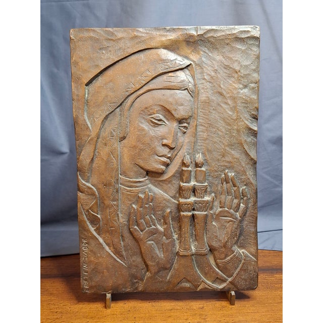 This impressive high-relief bronze sculpture depicts a traditional Jewish woman wrapped in a headscarf, reciting the...