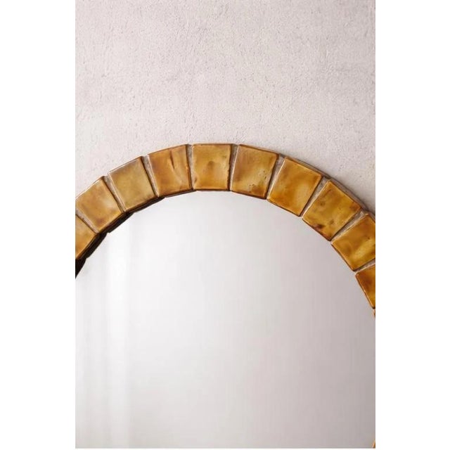 This handmade ceramic wall mirror was crafted by the Utrecht studio Mobach, a name primarily known for artistic ceramics...