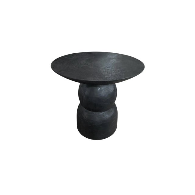 A wonderfully organic round side table. Its rich black pigment was achieved through burning the wood three times. Its...