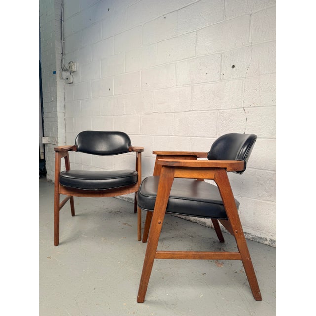 Elegant set of mid-century Murphy style chairs from Eck-Adams Corp. Featuring walnut frames and original black leather...