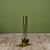 Three piece set of brass fireplace tools with stand. The set features three tools, shovel, broom and poker, all set on a...