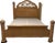 The king size bed has a tall arched headboard with decorative inset panels resembling a fan or sunburst design. Four...