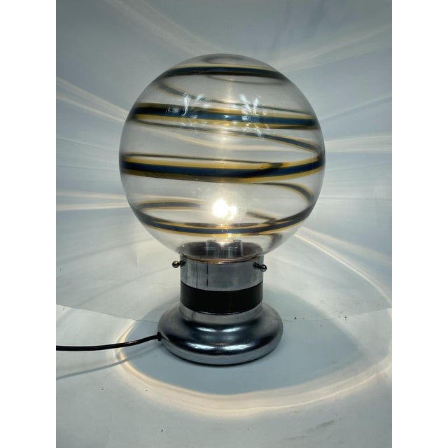 Beautiful table lamp with Murano glass globe and chromed/golden steel, 70s Toni Zuccheri design, Made in Italy. Perfectly...