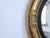 This 19th Century convex giltwood mirror has a rubbed gold patina.
