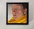 This intimate oil painting captures a serene moment, focusing on a figure enveloped in a vibrant yellow scarf. The soft,...
