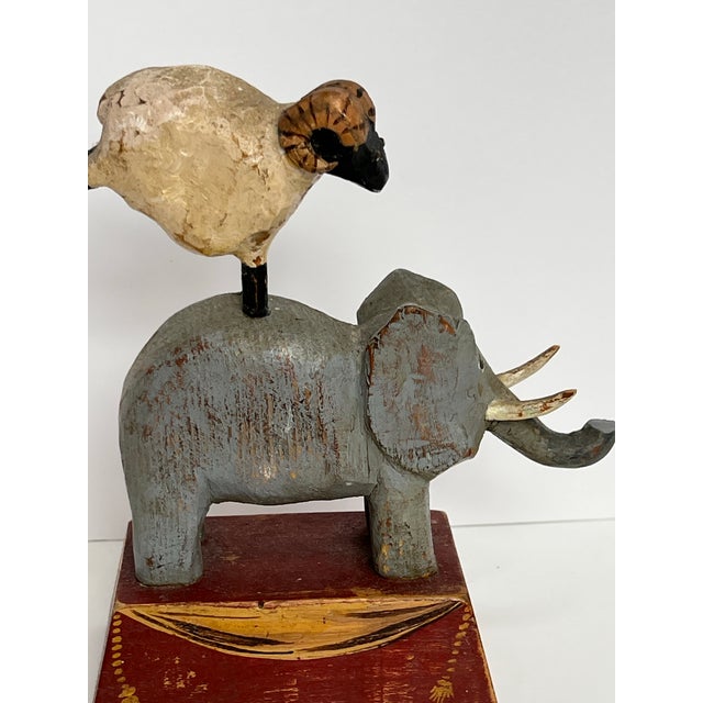 Signed, original Tom Kelly, folk artist sculture with elepahnat and ram standing on pedestal. Everything is hand painted...