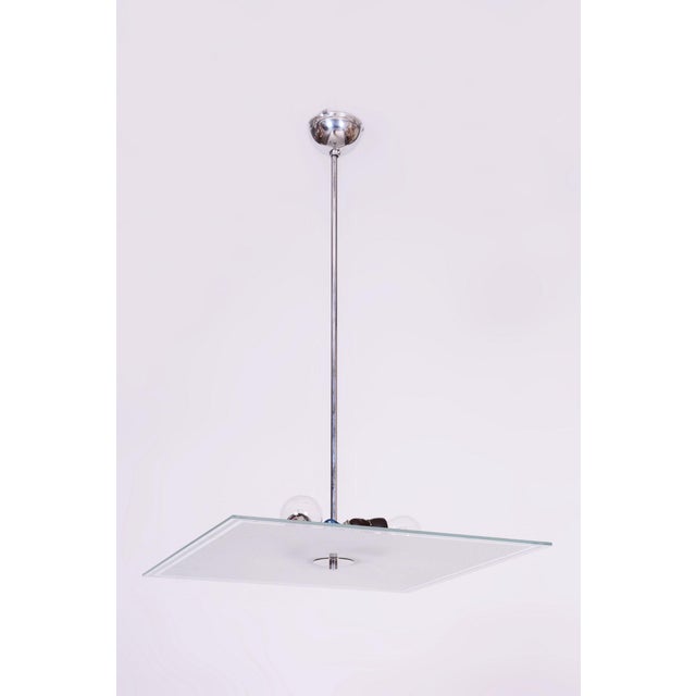 This chandelier is a prime example of functionalist elegance and the Bauhaus movement in 1930s Czechoslovakia. Its design...