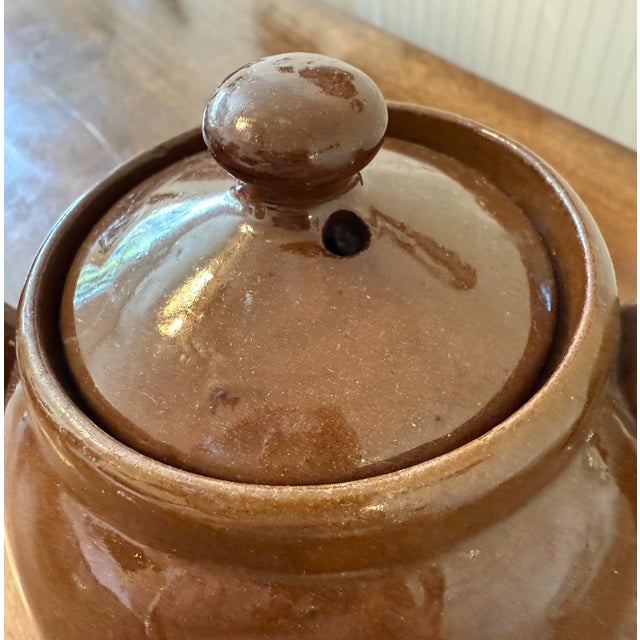 Enjoy this charming vintage teapot for your tea service or add it to your collection. This teapot is crafted from Redware...