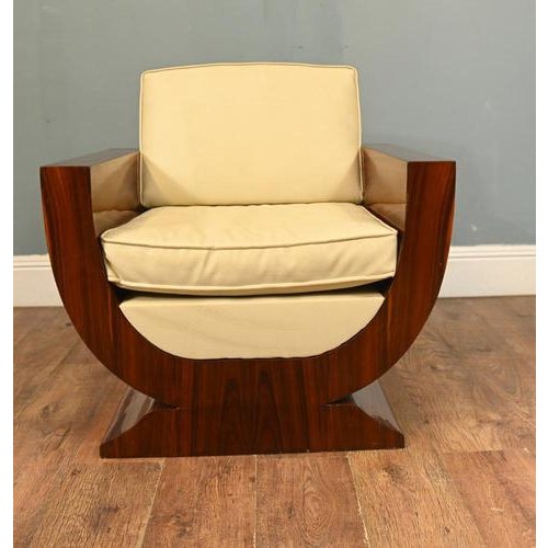 A striking Art Deco style armchair in richly figured walnut with bold, architectural lines The chair is defined by its...