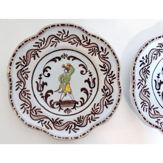 Antique pair of French faience complimentary plates featuring a maiden and a gent. These lovely hand painted plates are...