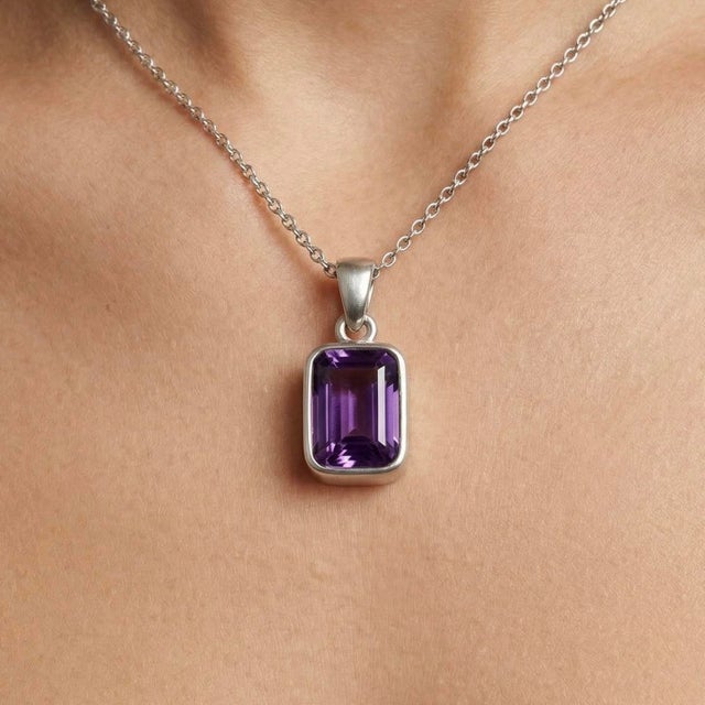 This elegant pendant features a captivating Amethyst gemstone, admired for its rich violet hue and timeless appeal. Known...